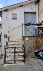 a staircase leading up to a building with flowers on it at SH Suite OLMO AC e Wi-Fi in Manziana