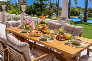 a wooden table with food and drinks on a patio at Gaia Residence in Argostoli