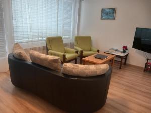 a living room with a couch and two chairs and a table at Casa Angela in Orselina