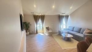a living room with a blue couch and a table at Azur Stay Nice in Nice