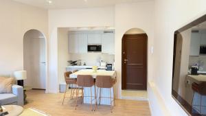 a kitchen and living room with a table and chairs at Azur Stay Nice in Nice