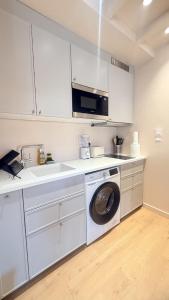 a kitchen with a washing machine and a sink at Azur Stay Nice in Nice