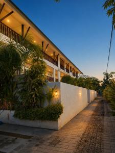 a building with plants on the side of it at Braban Sari Guest House Seminyak in Seminyak