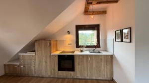 a kitchen with a sink and a window at Dana apartment with Garden near Tara National Park in Bajina Bašta