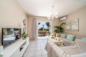 a living room with a couch and a tv at Gaia Residence in Argostoli