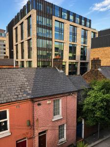 an old brick building in front of a large building at The Central Dublin Hostel in Dublin