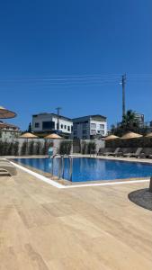 a large swimming pool with buildings in the background at KUZEY OTEL in Sinop