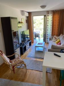a living room with a couch and a table at Eva in Pržno