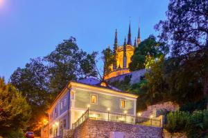 a building with a castle in the background at night at Boutique hotel Pod Barborou in Kutná Hora