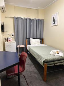 a bedroom with a bed and a desk and a table at Workforce Accommodation in Kalgoorlie