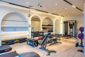 a gym with several treadmills and exercise equipment at Imperial Suites Hotel in Doha