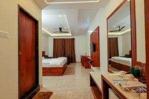 a hotel room with two beds and a mirror at Sunlit Shores Beach Villa in Kundapur
