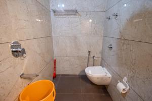 a bathroom with a toilet and a sink at Sunlit Shores Beach Villa in Kundapur +20 photos