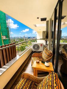 a balcony with two couches and a table on a building at SOLARIS APARTMENT-Sky Suites in Accra