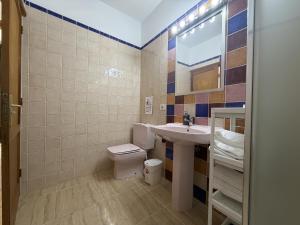 a bathroom with a sink and a toilet at Bajo junto al mar en El Tamaduste in Tamaduste +12 photos
