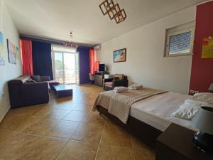 a bedroom with a bed and a living room at Apartments Art in Ulcinj