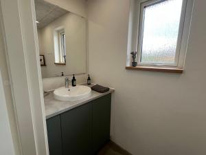 a bathroom with a sink and a mirror at Skansely in Sønderborg