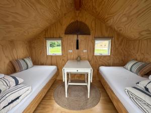 a small room with two beds and a table in it at Skansely in Sønderborg