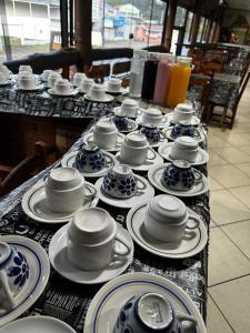 a table with blue and white china on it at Pousada Natalino Broleze in Águas de Lindoia +22 photos