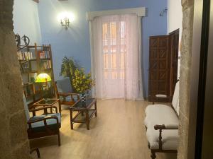 a living room with a couch and a window at Garden Suites Xativa Casa Rural in Xàtiva