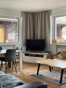 a living room with a television and a table at Apartment Angela in Mittersill