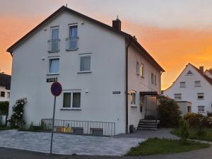 a white building with a sunset in the background at Ferienunterkunft Bella Italia in Friedrichshafen