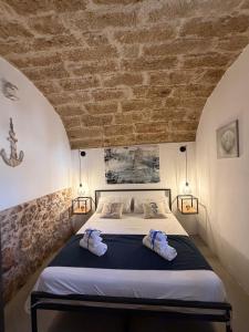 a bedroom with a bed with two towels on it at Sea Salt in Terrasini