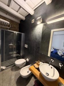 a bathroom with two sinks and a shower and a toilet at Sea Salt in Terrasini +13 photos