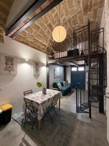 a living room with a loft bed and a table at Sea Salt in Terrasini