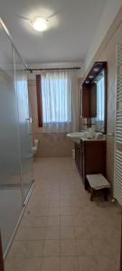 a large bathroom with a shower and a sink at RAMERAHouse in Mareno di Piave +7 photos