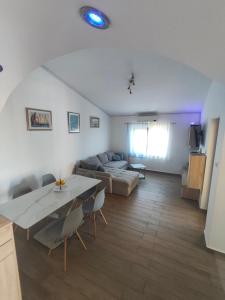 a living room with a couch and a table at Apartments Nagj in Sveti Juraj