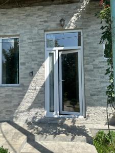 a sliding glass door on a brick house at Sweet Home in Dilijan