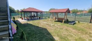 a backyard with a gazebo and a bench at Remetea 292 in Remetea