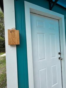 a door to a house with a blue door at The conch cottage in Crystal River