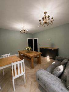 a living room with a couch and a table at 7 Bed, 7 BR Victorian Accom - Sleeps 14 in Walsall