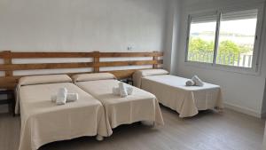a room with two beds and a window at VTAR Casa Carmen en Gilena in Gilena