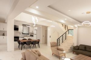 a living room and dining room with a table and chairs at Cesur Villa in Fethiye