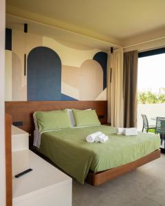 a bedroom with a bed with two towels on it at Daga Resort in Zambrone