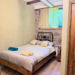 a bed sitting in a room with a window at HALI Guest Hause in Dilijan
