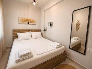 a bedroom with a bed with towels on it at Crystal 1 Apartment Ofrinio in Ofrínion