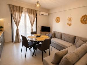 a living room with a table and a couch at Crystal 1 Apartment Ofrinio in Ofrínion