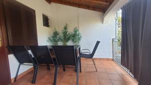 a table and chairs on a porch with a potted plant at UNIQUE Apartments Malinska in Malinska