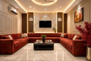 a living room with a red couch and a tv at Hotel Perfectionist- Free Airport Pickup in New Delhi