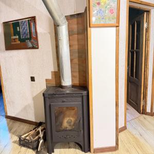 a wood stove in a room with a hallway at HALI Guest Hause in Dilijan +28 photos