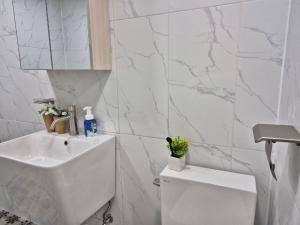a white bathroom with a sink and a toilet at Incheon 레토하우스 in Incheon +53 photos