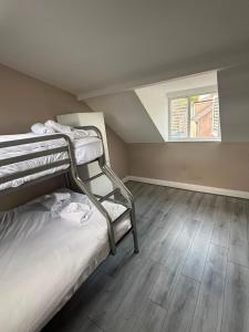 a bedroom with two bunk beds and a window at Shamrock Quay in Cork