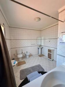 a bathroom with a toilet and a sink at West Gold in Praia de Mira +10 photos
