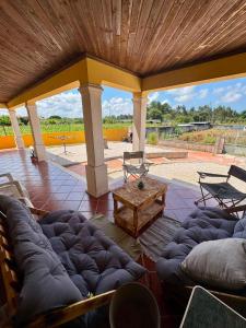a large covered patio with a couch and a table at West Gold in Praia de Mira