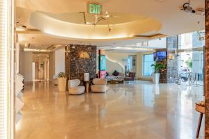 a lobby of a building with couches and chairs at Imperial Suites Hotel in Doha +81 photos