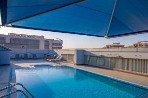 a large swimming pool on top of a building at Imperial Suites Hotel in Doha